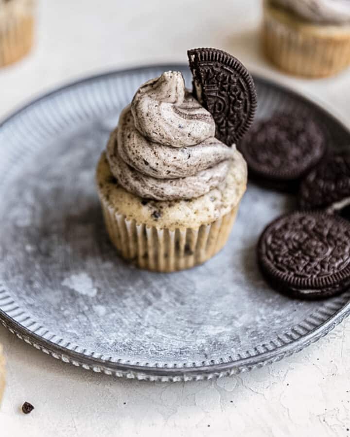A cupcake with Oreo buttercream frosting swirled on top.