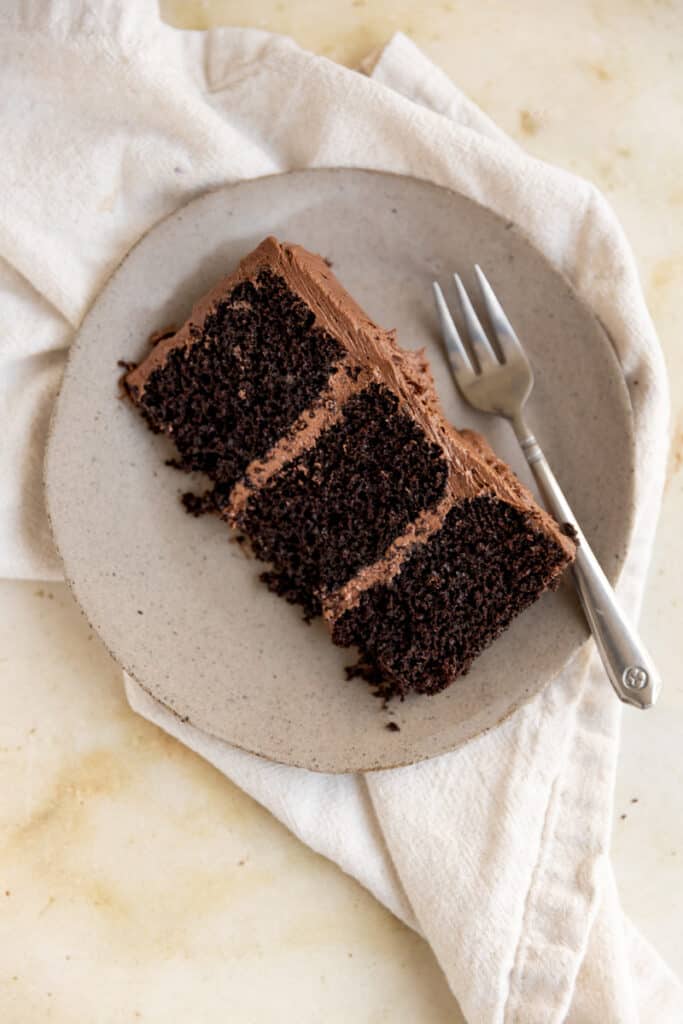 A slice of chocolate coffee cake on a gray plate.