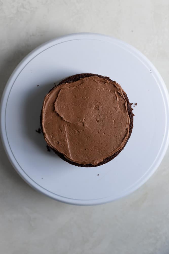 A chocolate cake layer filled with chocolate frosting.