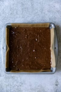 Fudgy brownie batter in a 8x8 pan.
