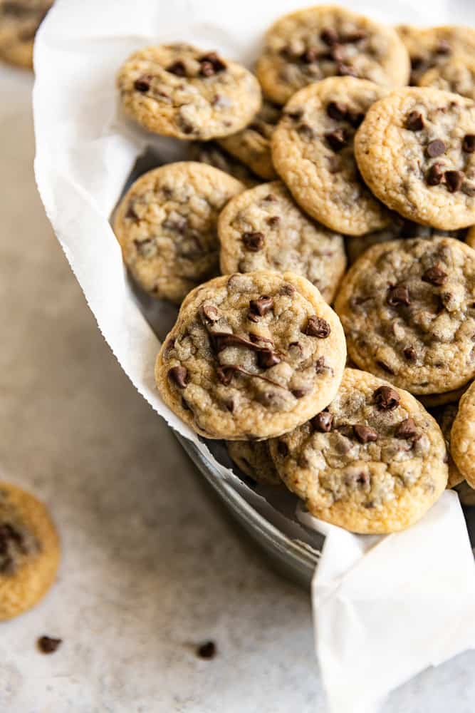 A closeup of a mini chocolate chip cookie in a cluster of cookies.