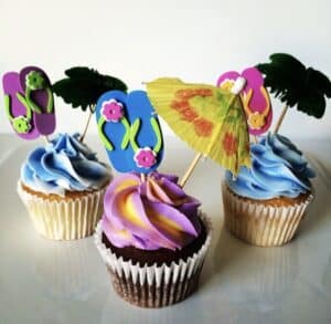 Hawaiian themed cupcakes on a white platter.