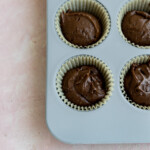 Brownie batter in a muffin tin.