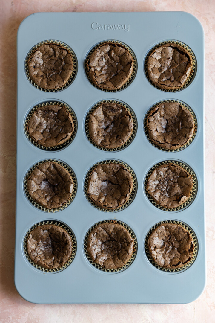 Baked brownie cupcakes in a muffin tin. 