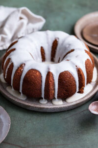 A bundt cake topped with a maple drizzle glaze.