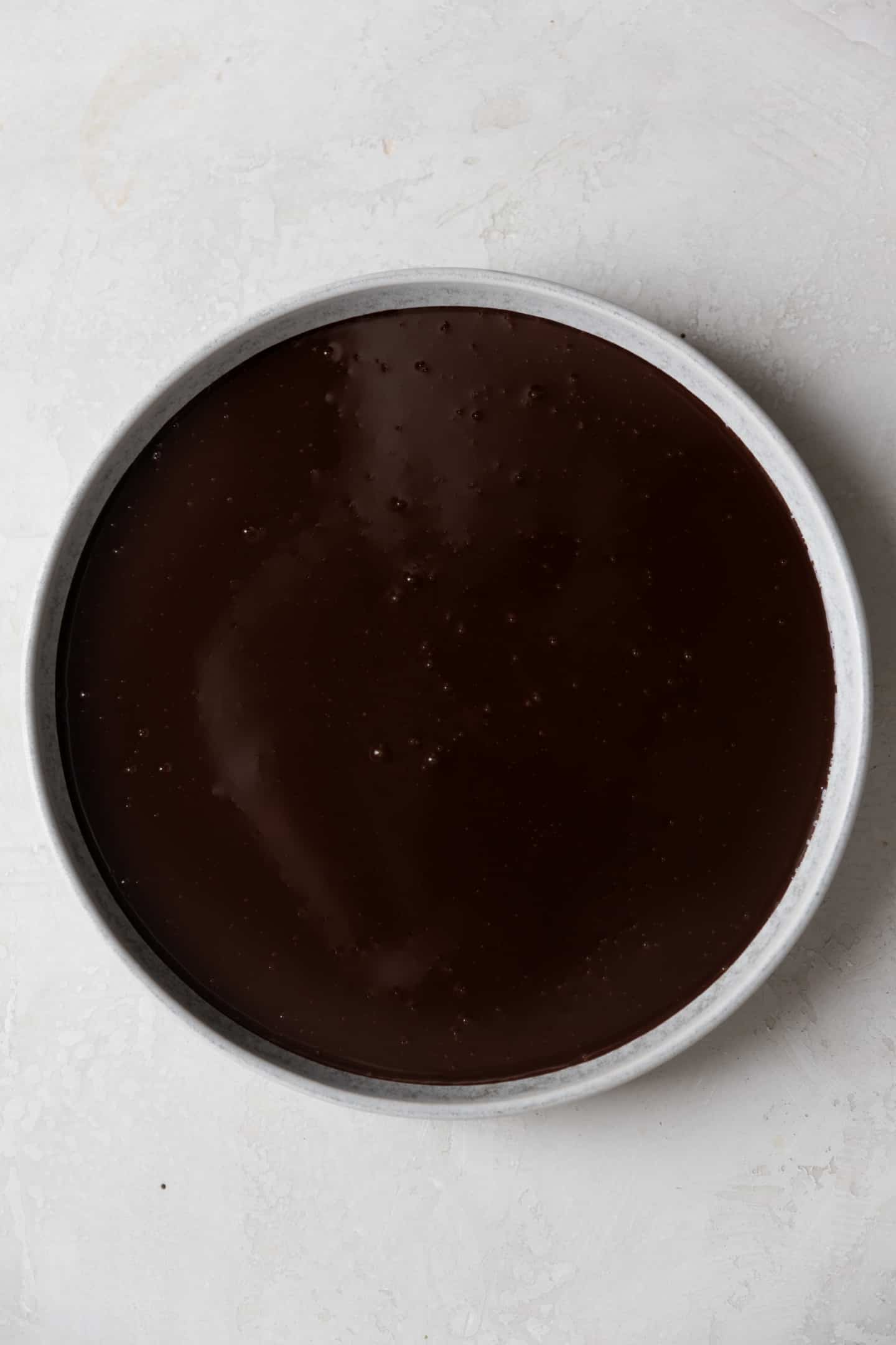Chocolate ganache in a shallow white bowl.