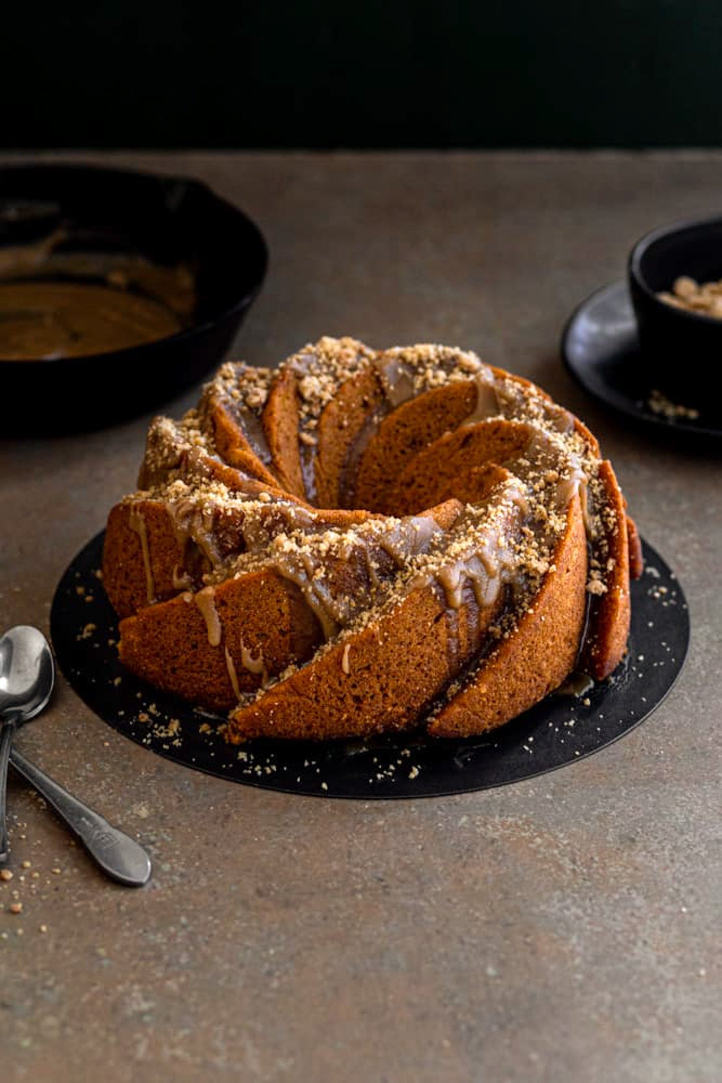 A bundt cake drizzled with glaze and streusel.