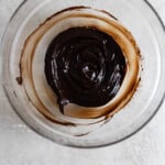Butter and cocoa powder melted and mixed together in a glass bowl.