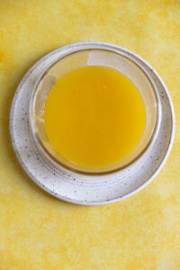 Lemon curd in a small glass container.