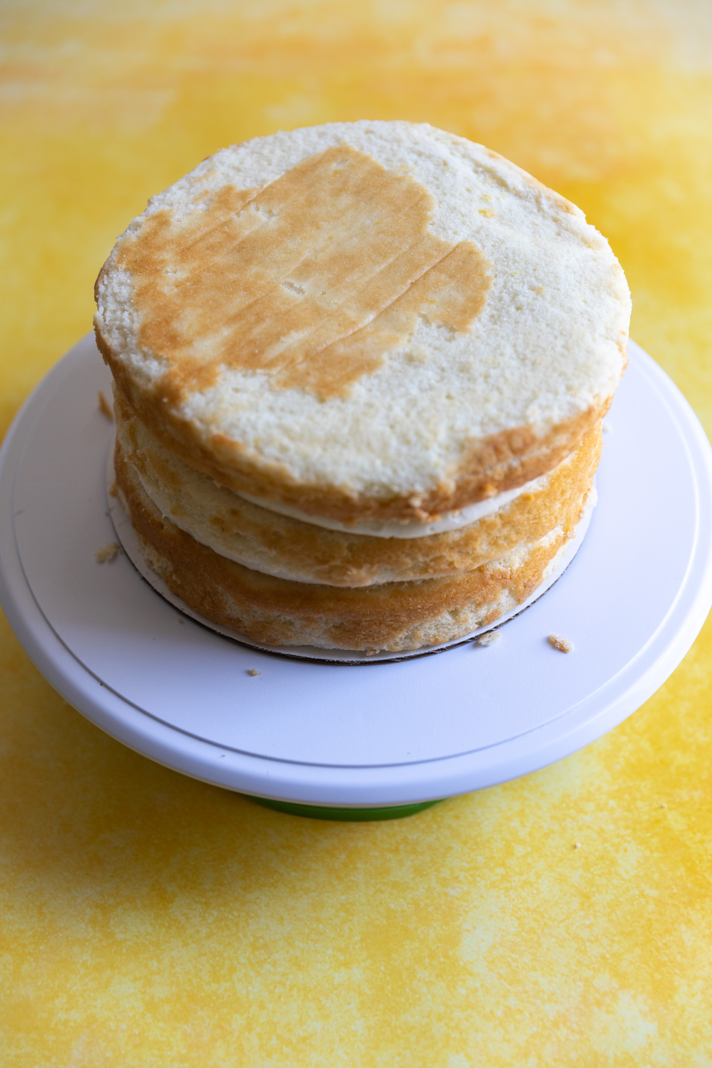 A lemon cake filled and stacked with lemon curd filling.
