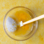 Eggs, lemon juice, and sugar in a glass bowl.