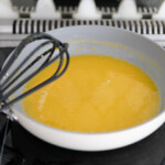 Lemon curd cooking on a stove top.