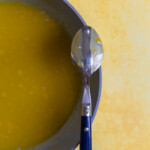 The back of a spoon coated with lemon curd.