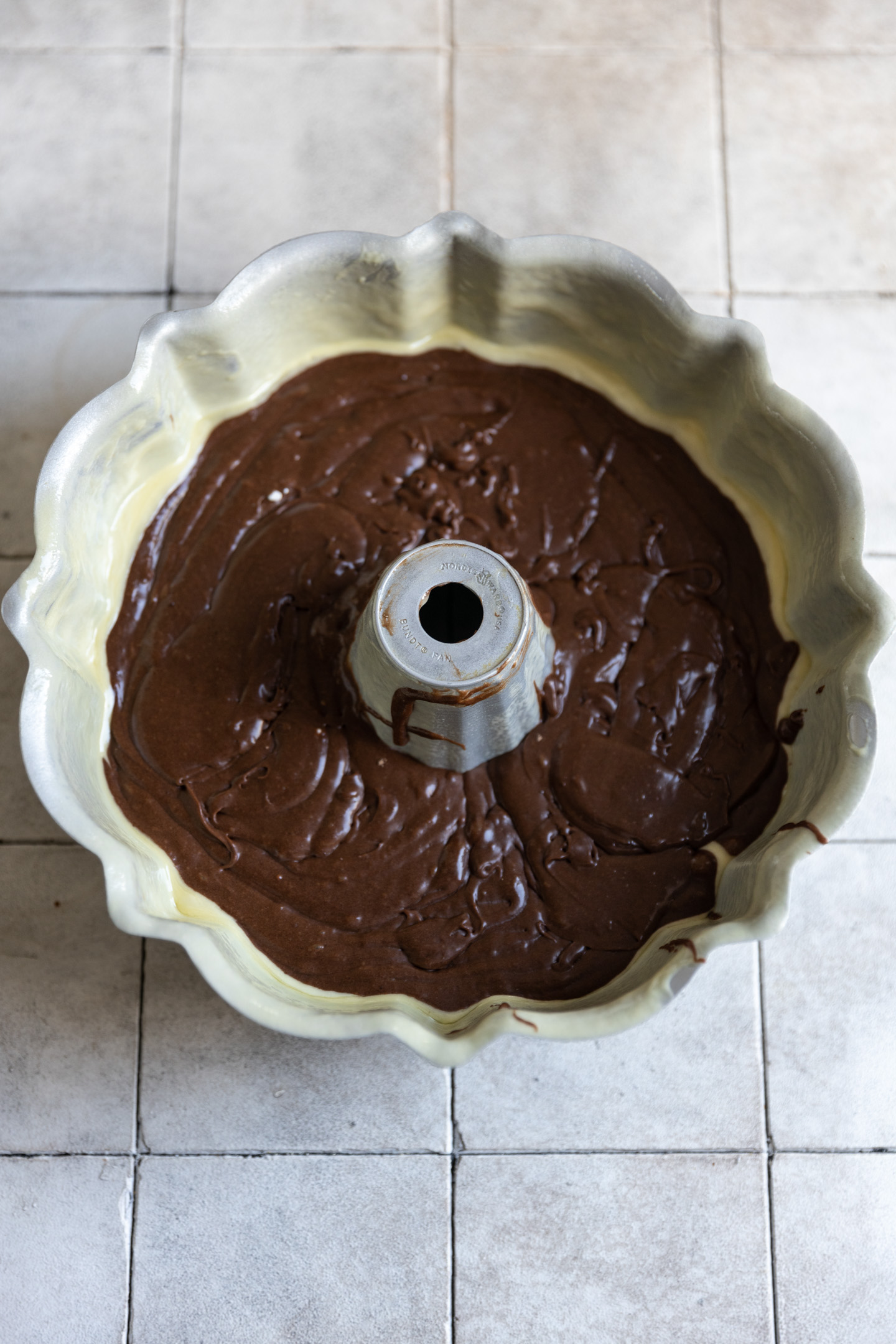 Brownie cake batter in a greased bundt pan.