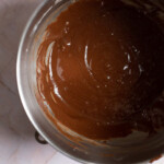 Chocolate fudge cupcake batter in a stainless steel mixing bowl.