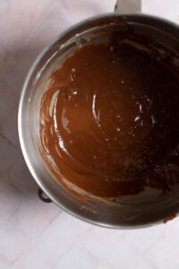 Chocolate fudge cupcake batter in a stainless steel mixing bowl.