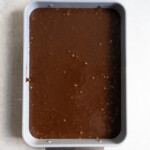 Chocolate cake batter in a 9x13 inch pan.