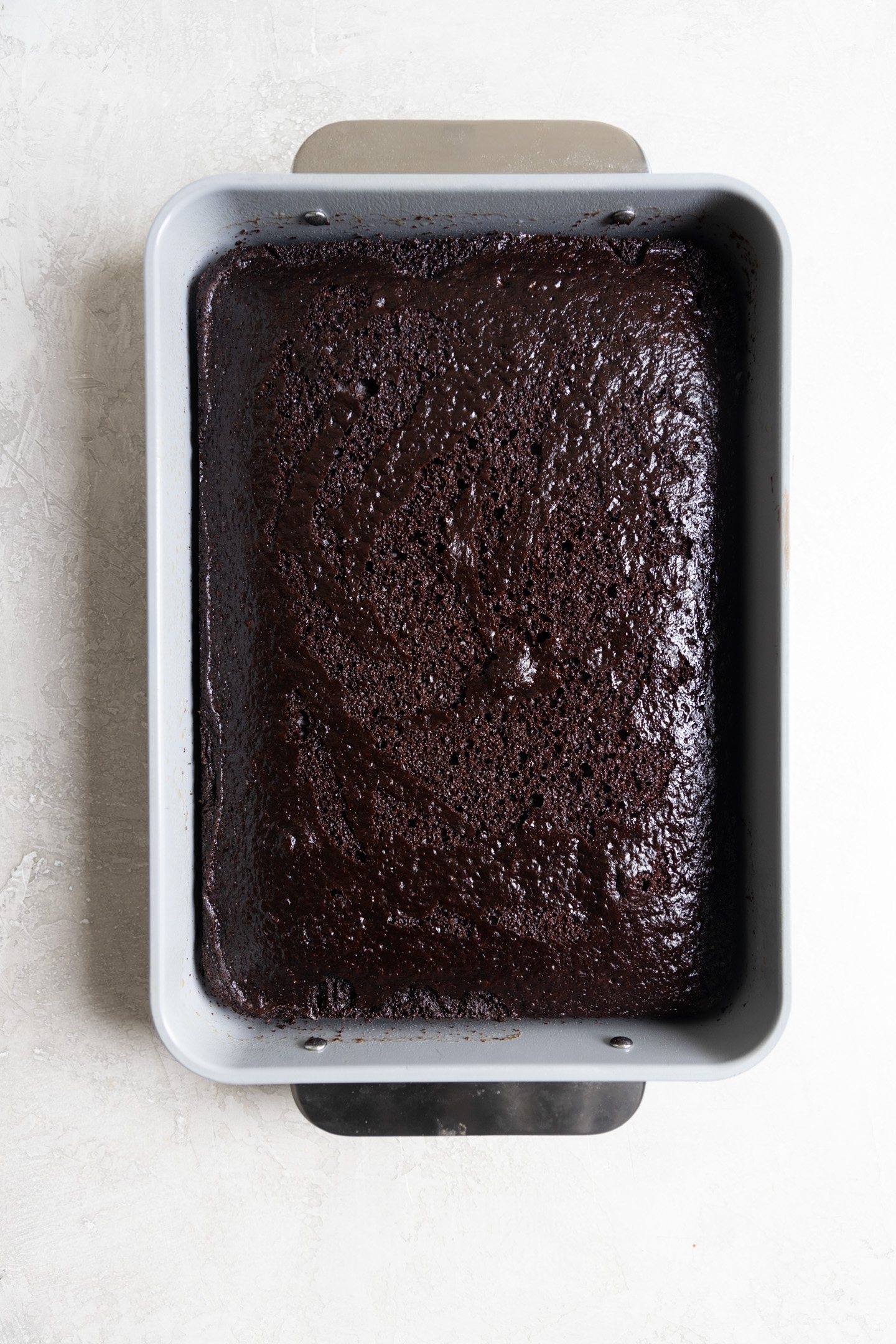 A chocolate cake in a 9x13 pan.