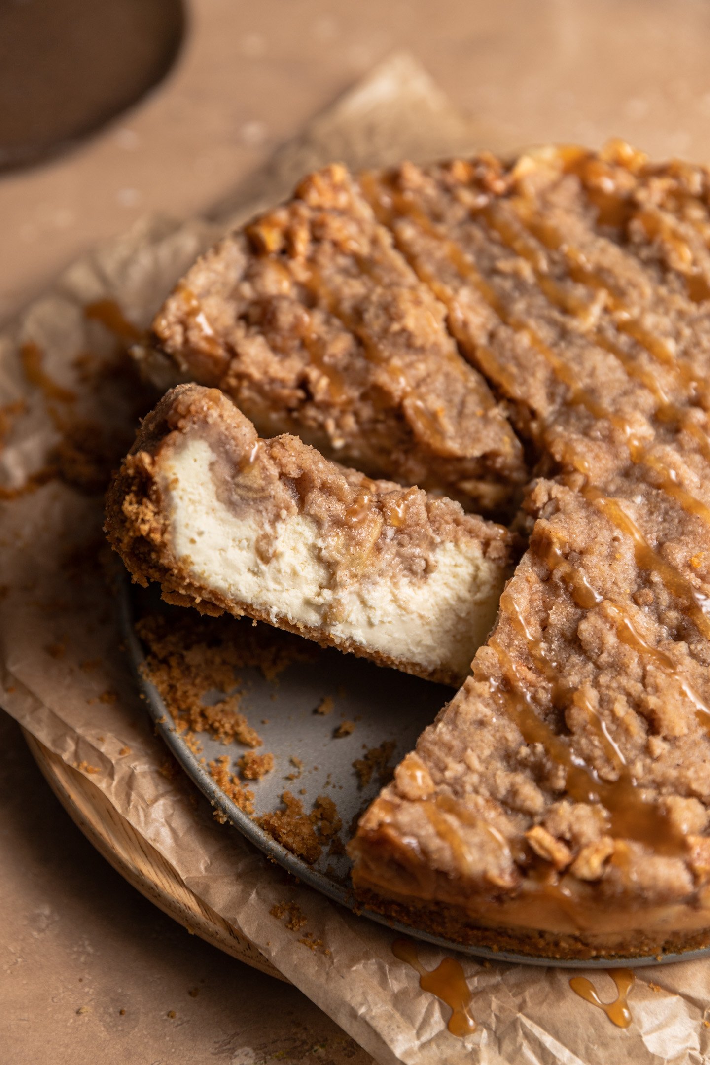 An apple pie cheesecake slice on its side.