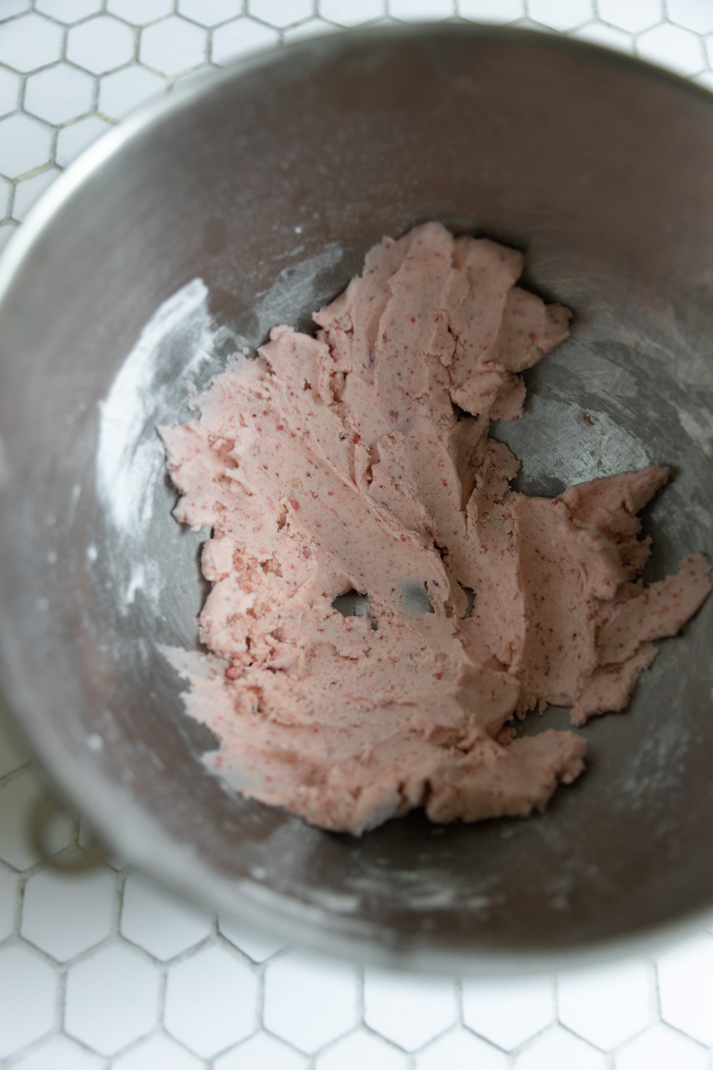 Strawberry frosting in a mixing bowl.