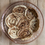 Cinnamon rolls flattened to form a crust in a pie plate.
