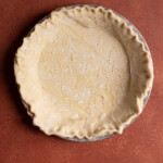 Puff pastry lining a pie plate.