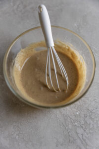 Coffee glaze whisked in a bowl.