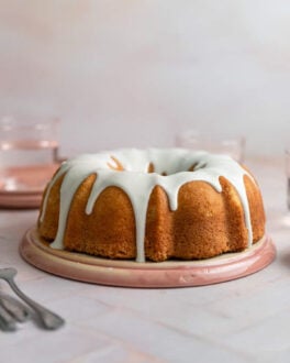 A vanilla bundt cake with a white glaze on top.
