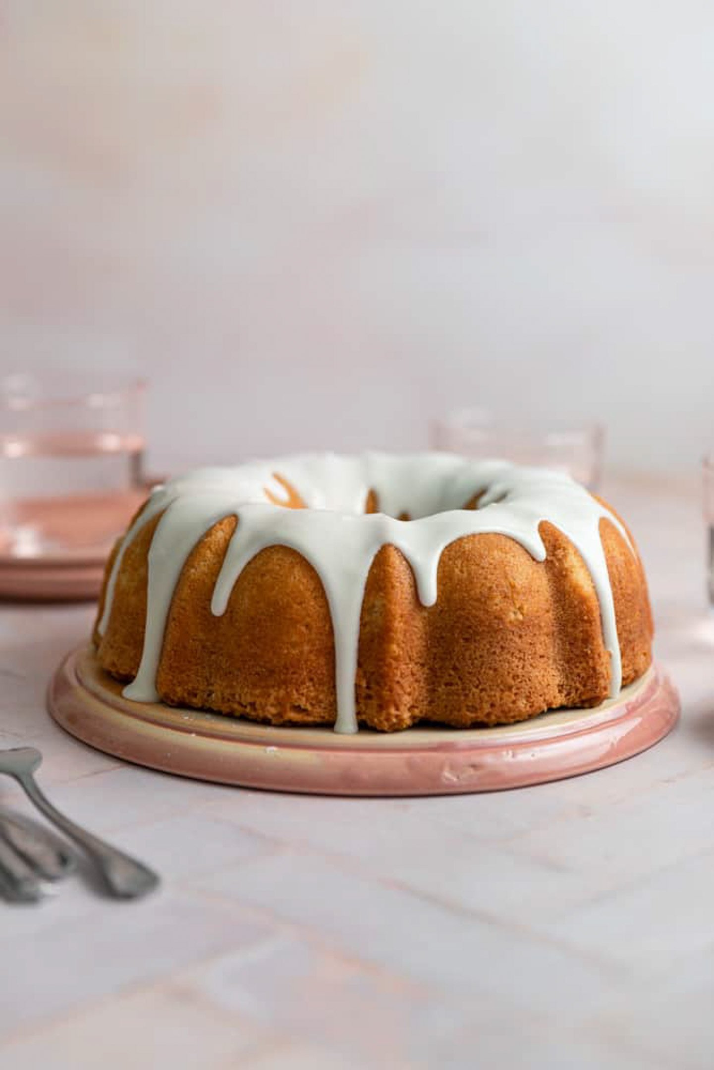 A vanilla bundt cake with a white glaze on top.