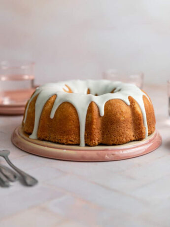 A vanilla bundt cake with a white glaze on top.