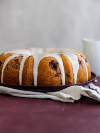 A white chocolate raspberry cake with glaze on top.