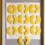 Pineapple slices drying on a sheet tray.