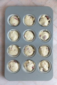 Raspberry cupcake batter in a muffin tin.