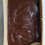 Brownie batter smoothed in a 9x13" pan.