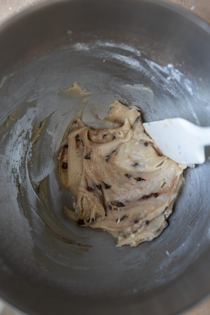 Raw cookie dough mixed in a mixing bowl.