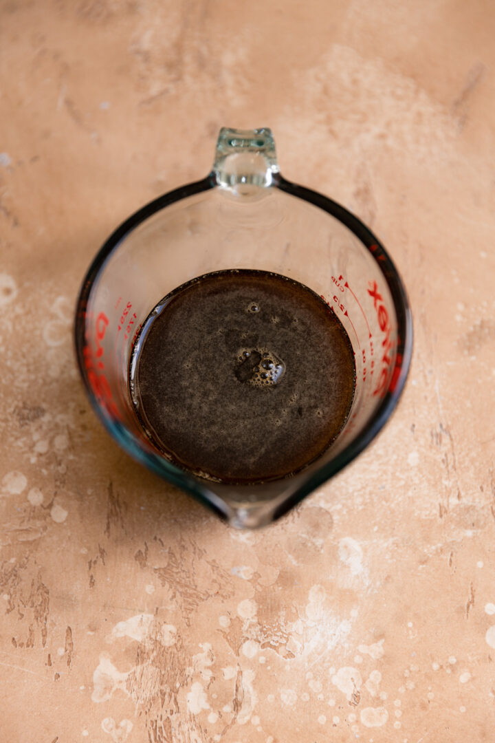 Brown sugar syrup in a measuring cup.