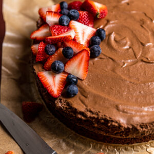 A chocolate mousse cake with berries on top.
