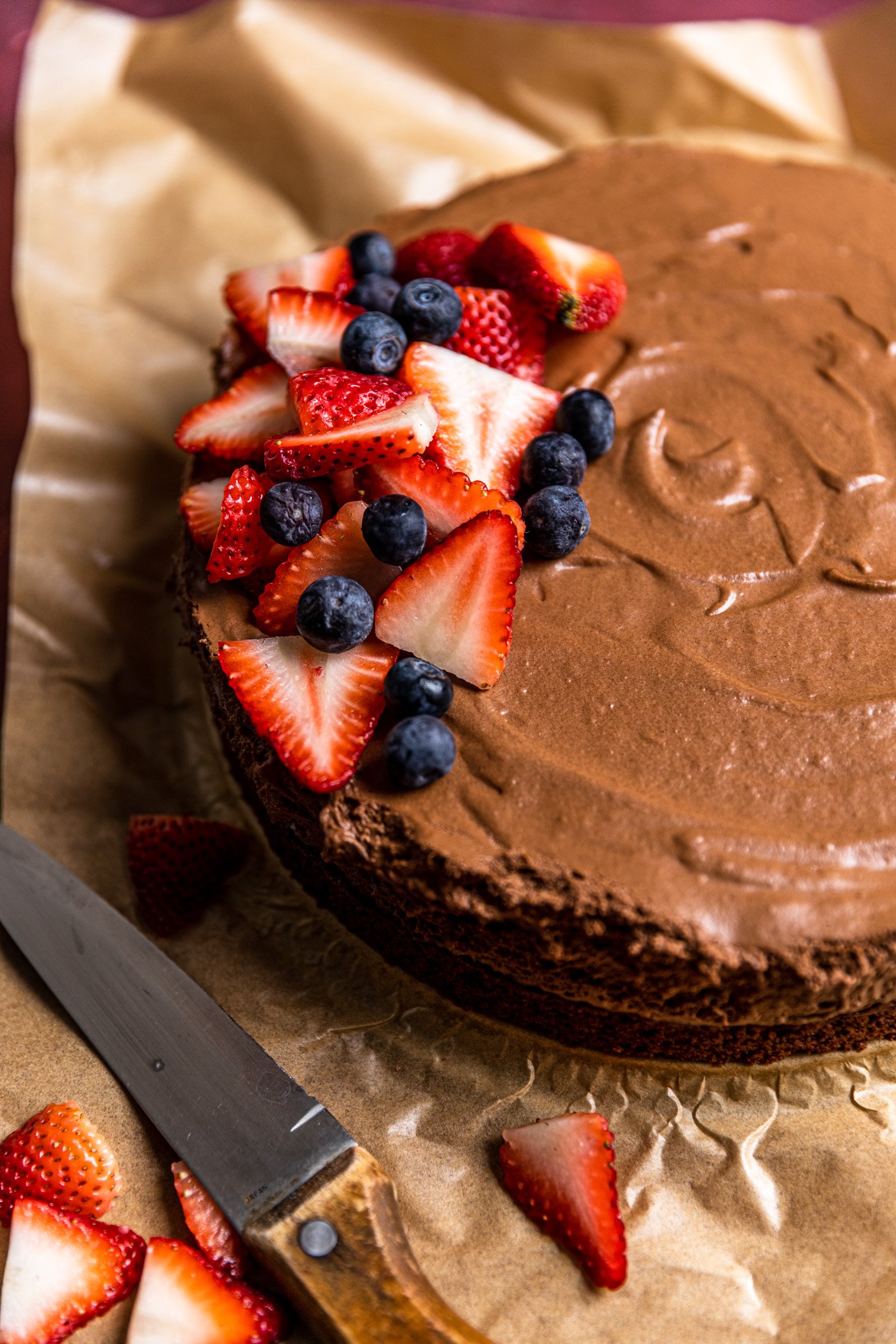 A chocolate mousse cake with berries on top. 