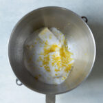 Sugar, butter, and zest in a mixing bowl.