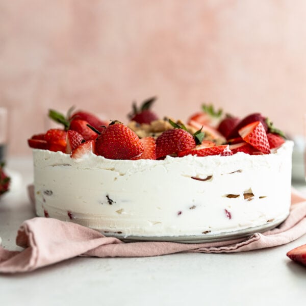 A strawberry icebox cake garnished with strawberries on top.