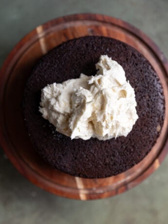 A chocolate cake with white frosting on top.