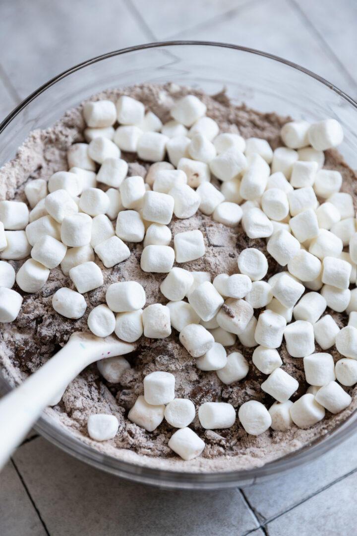 Marshmallows on top of muffin batter.