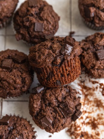 Triple chocolate muffins on a tiled backdrop.