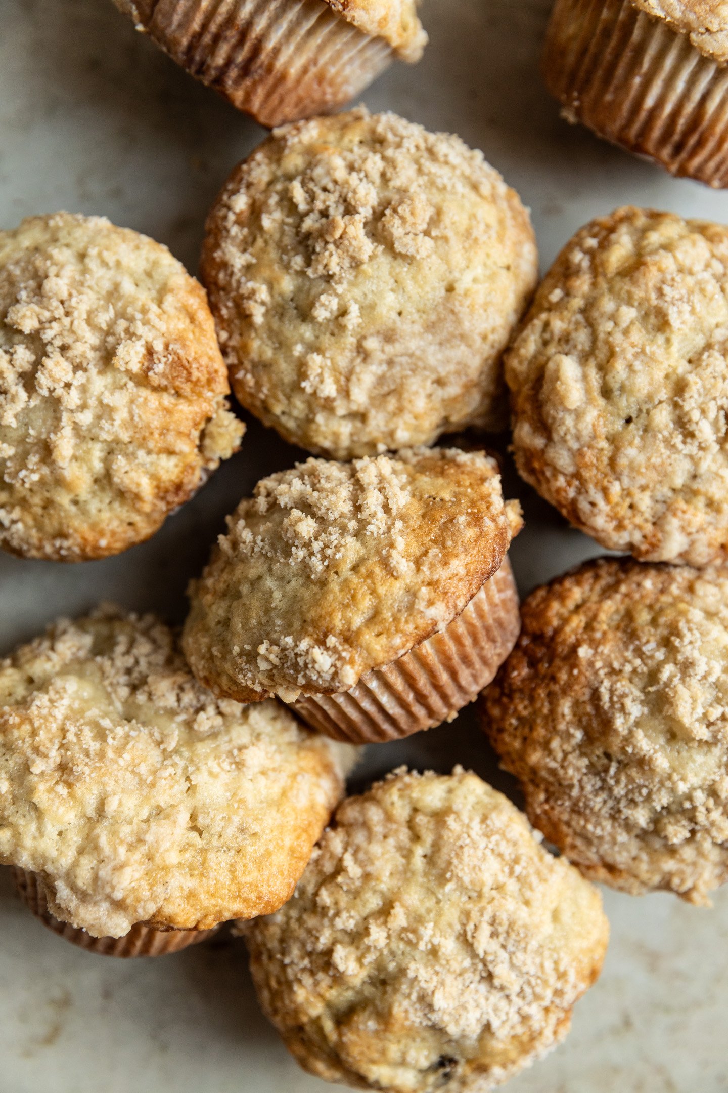 Banana muffins clustered together on a surface.