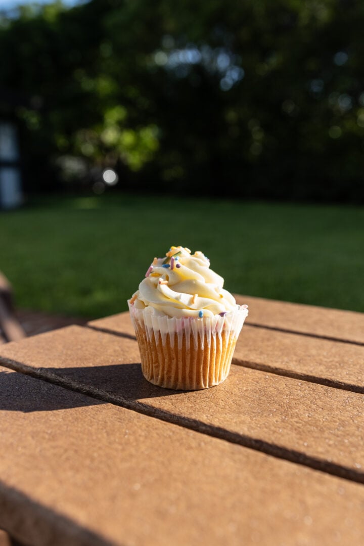 A melty vanilla cupcake in the direct sun. 