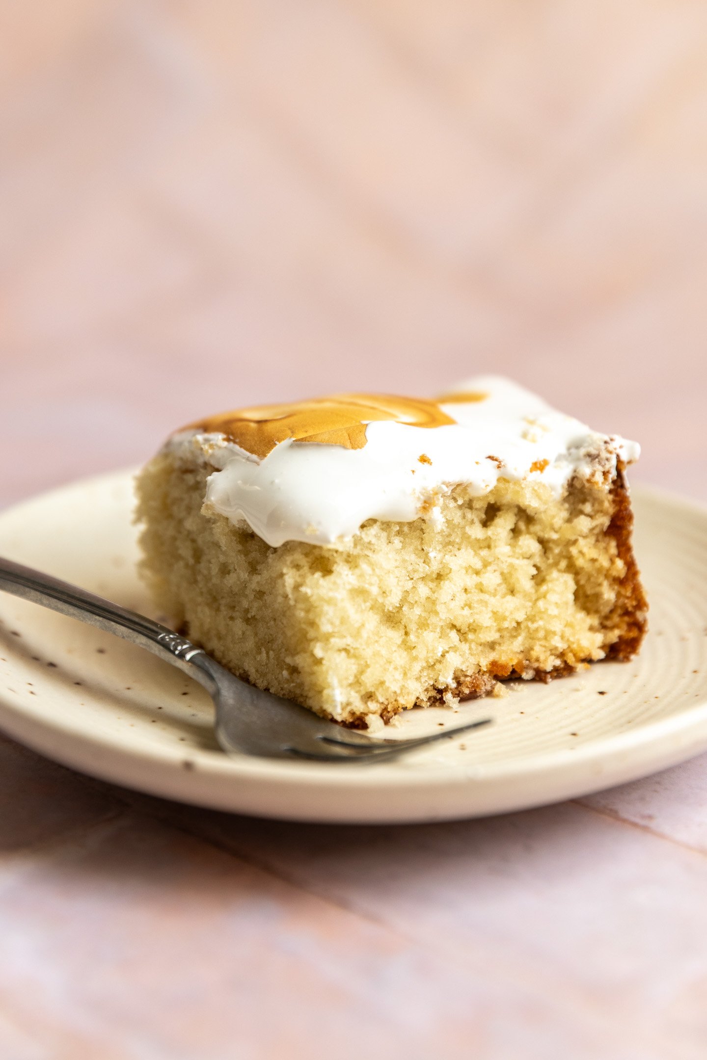 A slice of vanilla sheet cake on a plate. 