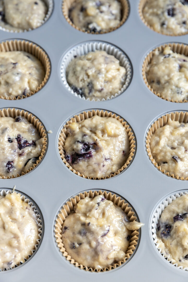 Muffin tin filled with muffin batter.