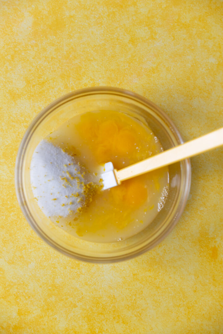 Ingredients for lemon curd in a bowl. 