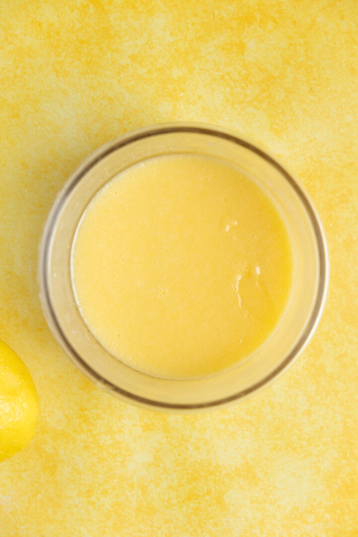 Lemon curd in a glass bowl.