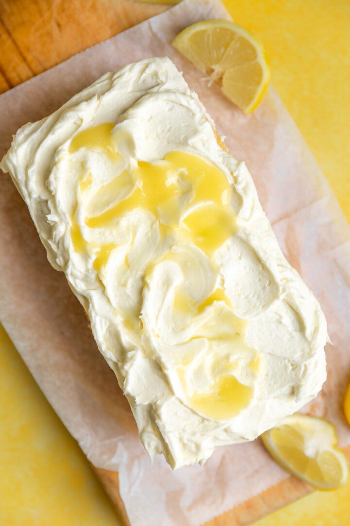 A loaf cake topped with lemon curd frosting. 
